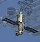 A computer-generated image of a module. The module is a stepped cylinder covered in white insulation, with a spherical compartment and airlock at one end. Two blue solar arrays project from the module, as does a robotic arm. Several other pieces of ISS hardware, faded to highlight the module, are visible in the background.