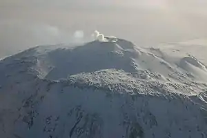  Distant view of a mountain with a smoke emission from its summit