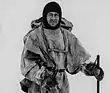 Man in winter coat wearing a balaclava or ski mask style headgear.